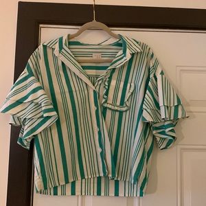 Ruffled white and green blouse.